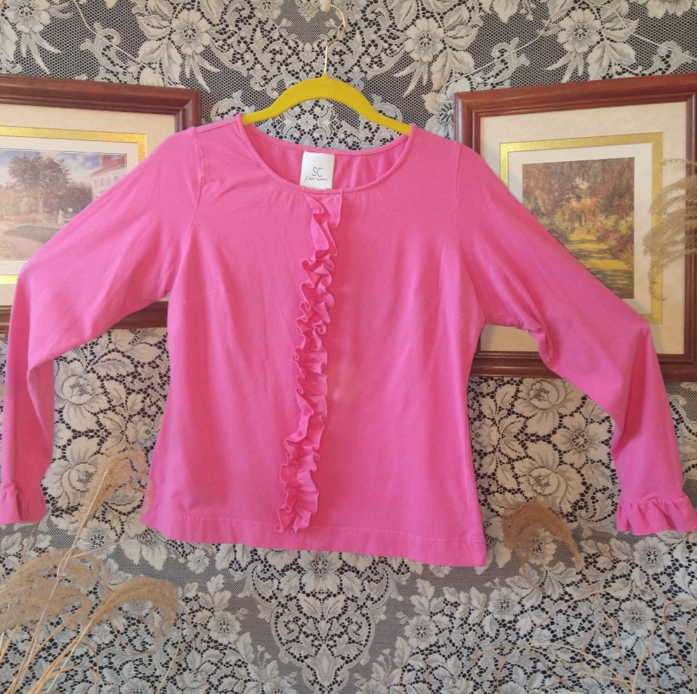 Sara Campbell hot pink long sleeve shirt with ruffles on front and sleeve cuffs